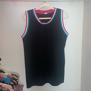 Unmarked black jersey with turquoise, pink, & white collar & sleeves